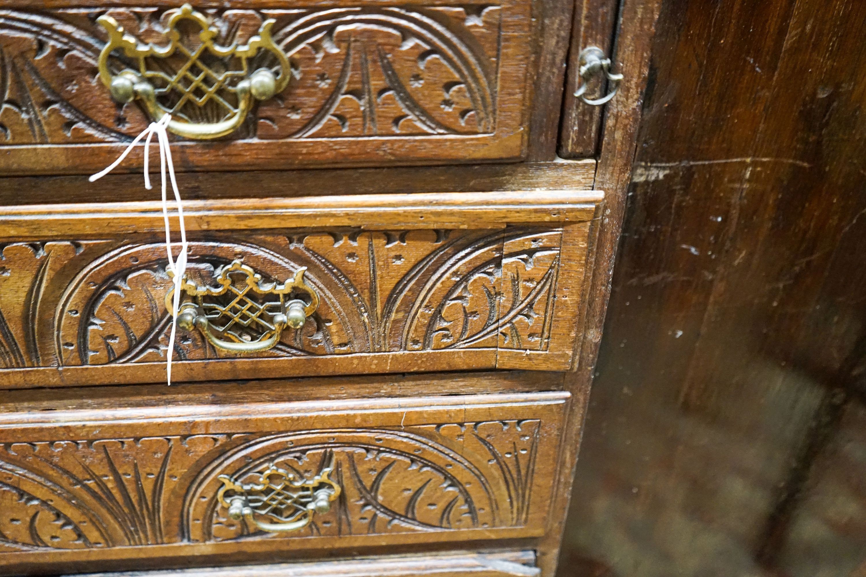 A George III later carved oak bureau, width 91cm, depth 50cm, height 106cm